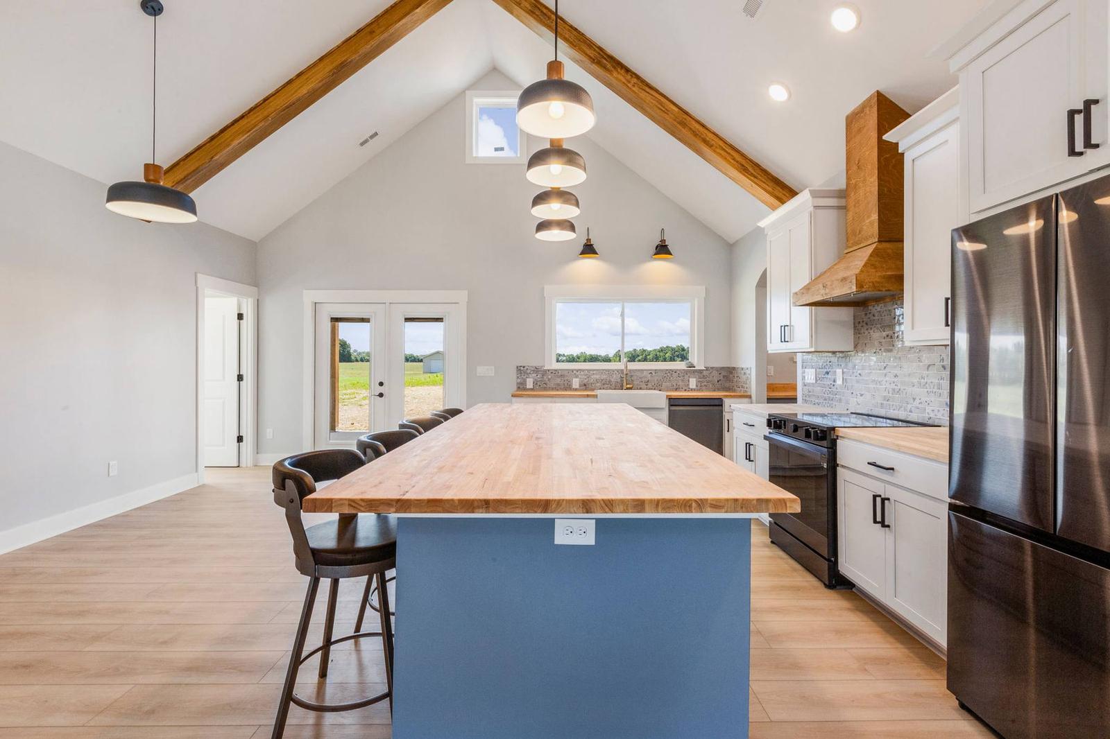The Hideaway kitchen with butcher-block island and vaulted, beamed ceiling