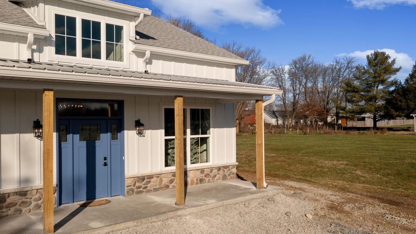 Board-and-batten with a stone skirt on the Kress Cottage.